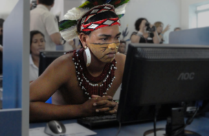 A young Brazilian man checks out the new computer center in the city of Cabrália, Brazil