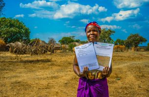 Zambian woman holds land titles.