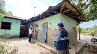 two people surveying a building