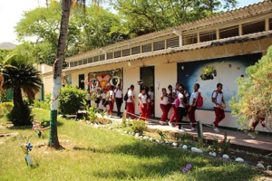 a group of schoolchildren walk in a line 