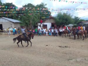 The Palenquera diaspora has kept alive language and oral traditions as well as a rich cultural heritage of cuisine, dance, and music. Above, the Santo Madero community displays horseback riding skills at a community fiesta