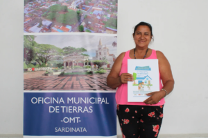 women landowner receives a land title through the Municipal Land Office in 2022