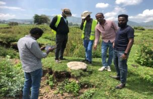 A group of men record data on agriculture