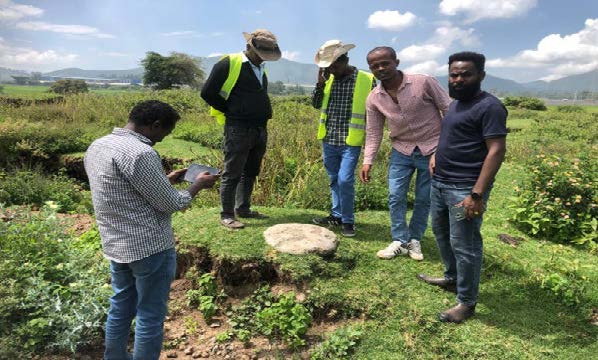 A group of men record data on agriculture